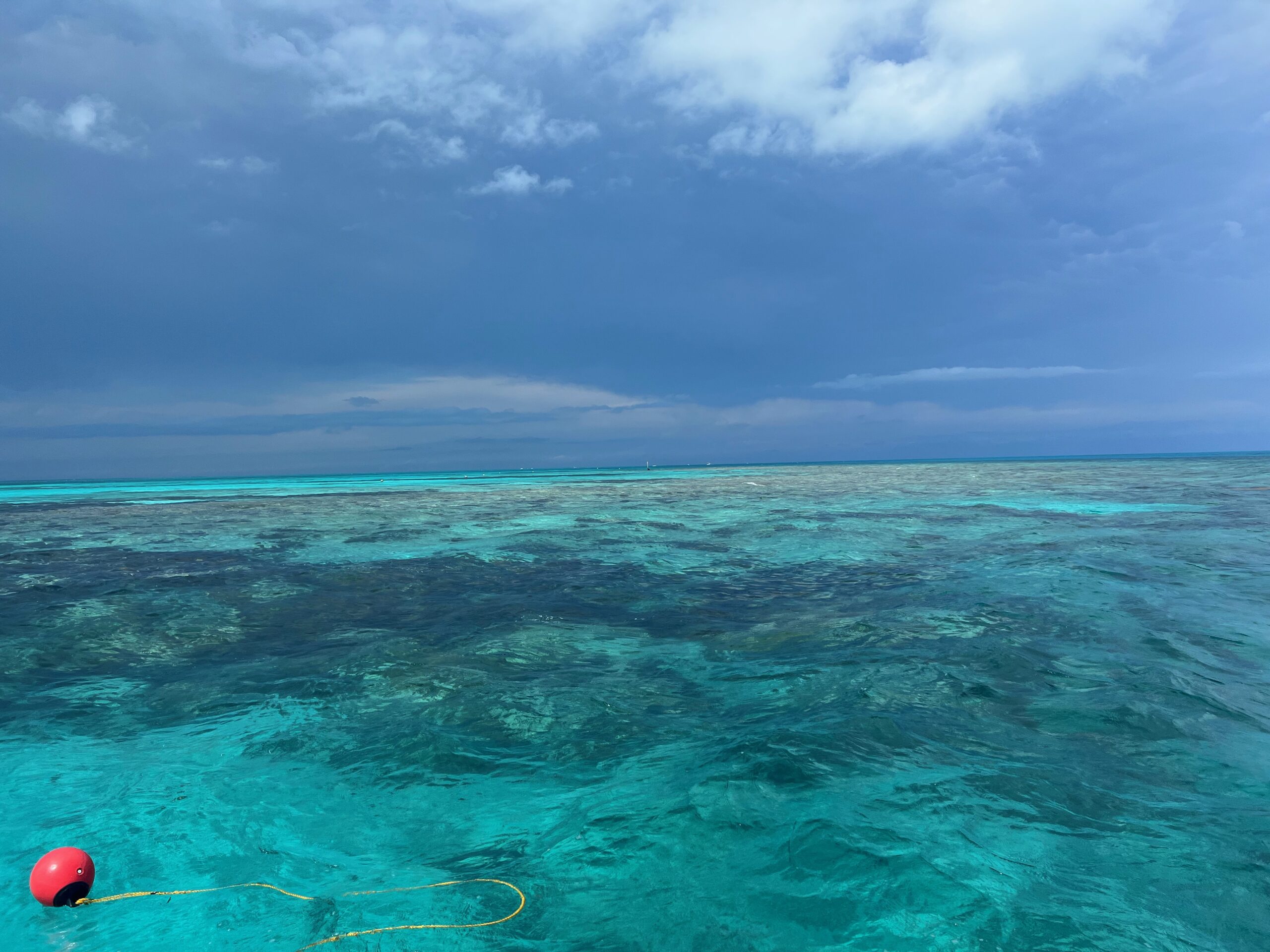 Photograph of Grecian Reef taken from the south end. The water is clear and you can see the reef post in the distance