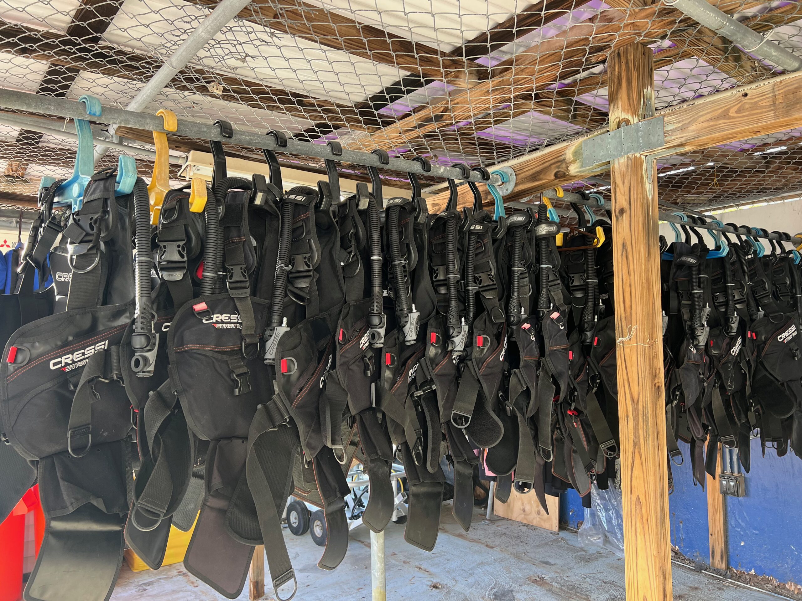 High quality SCUBA equipment for rent. Hanging neatly in storage area at Island Ventures
